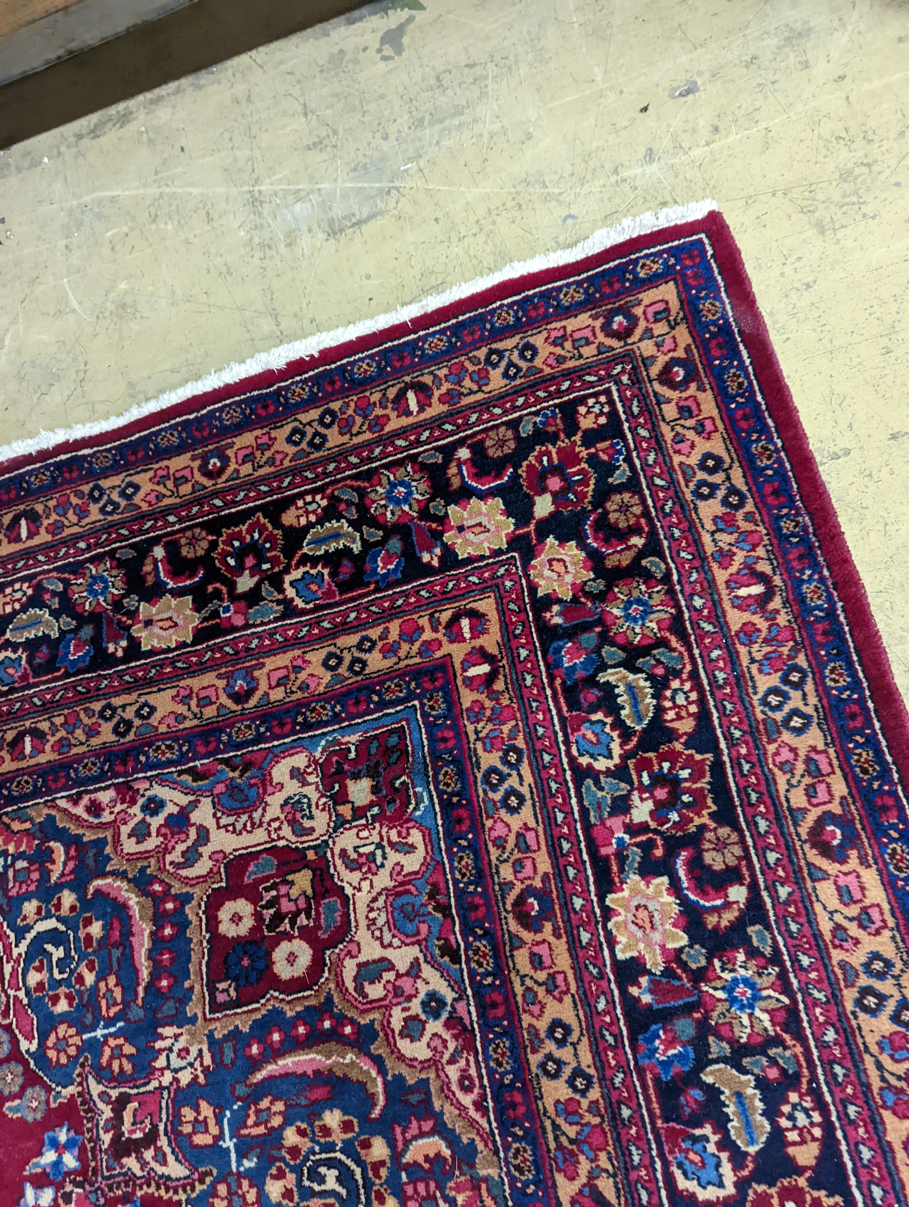 A Tabriz burgundy ground carpet, 350 x 250cm